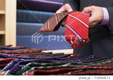 Midsection Of Businessman Selecting Ties 73660671