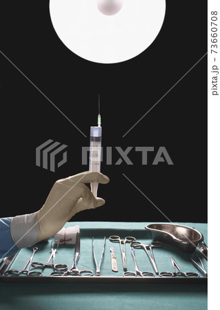 Hand Holding Syringe By Medical Equipment Hand Holding Syringe By Medical Equipment 73660708