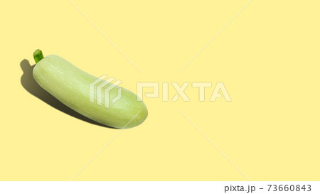 Ripe zucchini on a yellow background with copy space. 73660843
