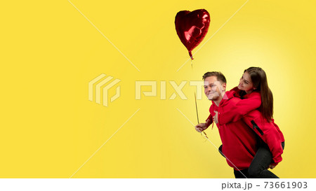 Beautiful couple in love on yellow studio background. Valentine's Day, love and emotions concept Beautiful couple in love on yellow studio background. Valentine's Day, love and emotions concept 73661903