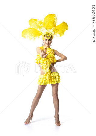 Beautiful young woman in carnival, stylish masquerade costume with feathers dancing on white studio background. 73662401