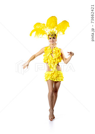 Beautiful young woman in carnival, stylish masquerade costume with feathers dancing on white studio background. Beautiful young woman in carnival, stylish masquerade costume with feathers dancing on white studio background. 73662421