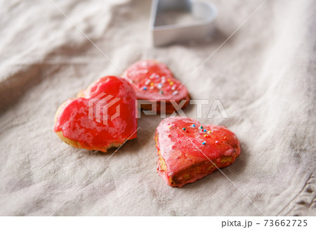 Heart shaped red hand made cookies and hibiscus tea. Heart shaped red hand made cookies and hibiscus tea. 73662725