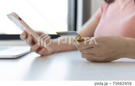 Businesswoman use mobile phones to register for security Online with a credit card to buy products online through application, Online shopping or Internet technology concept. 73662956