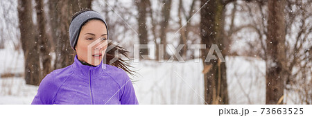 Winter run Asian runner woman running outside in park forest. Winter sport panorama banner. Healthy active girl doing workout. Winter run Asian runner woman running outside in park forest. Winter sport panorama banner. Healthy active girl doing workout. 73663525