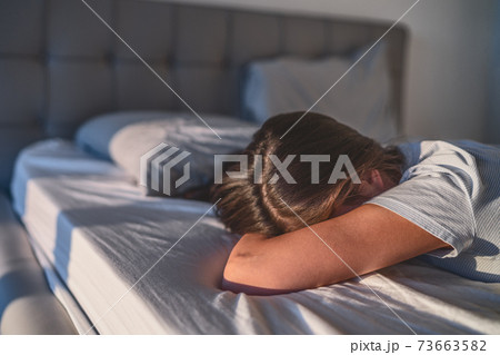 Home quarantine self isolation woman tired bored cant get up of bed staying asleep late afternoon sleepiness sleep disorder. Sad single girl crying alone Home quarantine self isolation woman tired bored cant get up of bed staying asleep late afternoon sleepiness sleep disorder. Sad single girl crying alone 73663582