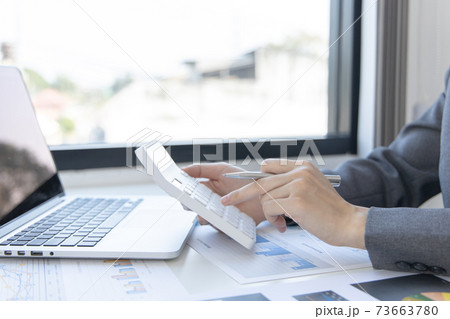 Accounting businesswomen are calculating income-expenditure and analyzing real estate investment data, Dedicated to the progress and growth of the company, Financial and tax systems concept. Accounting businesswomen are calculating income-expenditure and analyzing real estate investment data, Dedicated to the progress and growth of the company, Financial and tax systems concept. 73663780