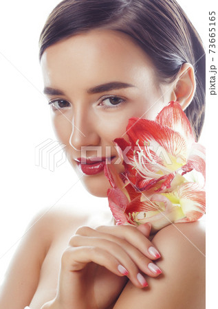 young pretty brunette real woman with red flower amaryllis close up isolated on white background. Fancy fashion makeup, bright lipstick, creative Ombre manicured nails young pretty brunette real woman with red flower amaryllis close up isolated on white background. Fancy fashion makeup, bright lipstick, creative Ombre manicured nails 73665165