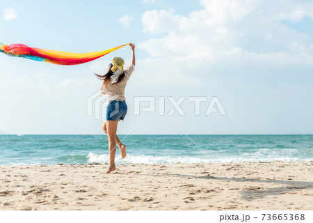Summer Vacation. Lifestyle woman walking and jumping relax happy on beach Summer Vacation. Lifestyle woman walking and jumping relax happy on beach 73665368