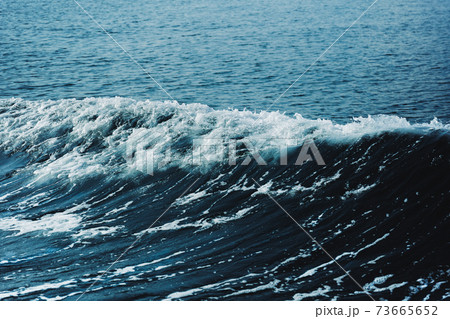 Blue sea water with white wave for background. 73665652