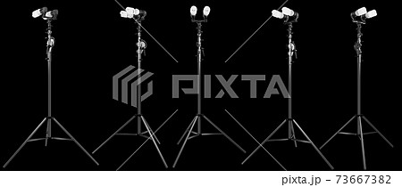 Lightbulb in lamp holder on studio stand isolated on black background 73667382