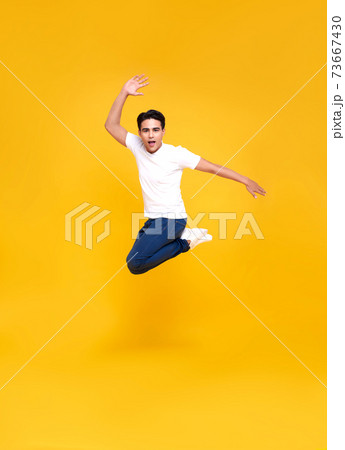 Young happy handsome Asian man jumping 73667430