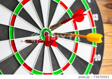 The darts on wooden background. Close up. 73670081