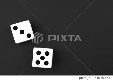 casino dices on the black background. Close up. casino dices on the black background. Close up. 73670224