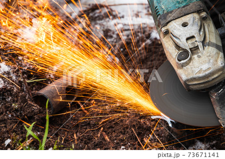 Angle grinder works, sparks stream close up 73671141