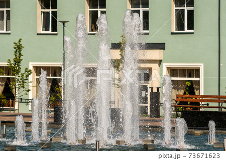 Fountain on a bright sunny day in a city square Fountain on a bright sunny day in a city square 73671623