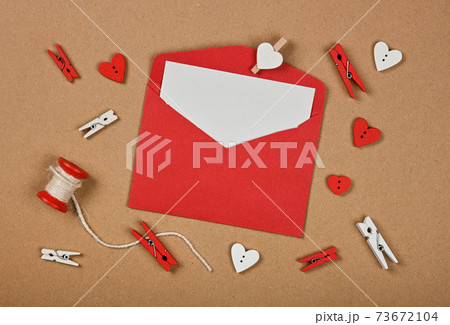 Red Valentine card envelope on brown paper 73672104