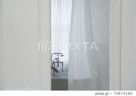 Woman's Hand Filling Bathtub Woman's Hand Filling Bathtub 73674182