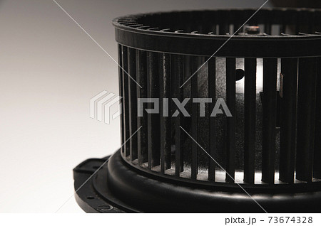 Heater motor. A spare part for an automobile heating system on a black-gray gradient background. Low key high contrast 73674328