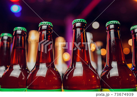 Close-up of the brown glass bottle necks. Narrow depth of field. 73674939
