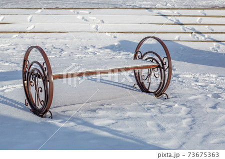 Comfortable bench in a winter resort town 73675363