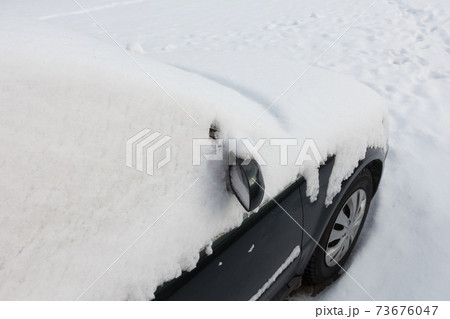 The mirror of the car is covered with snow. 73676047