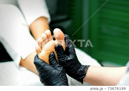 Young woman receiving foot massage Young woman receiving foot massage 73676199