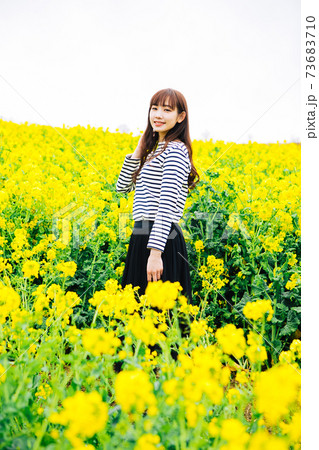 菜の花畑に立つ女性 菜の花畑に立つ女性 73683710