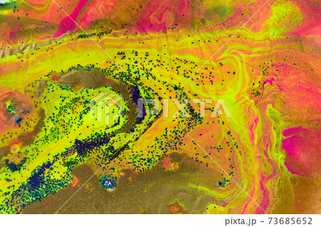 Mixed colorful inks with gold, green and blue glitter. Marble style background. Mixed colorful inks with gold, green and blue glitter. Marble style background. 73685652