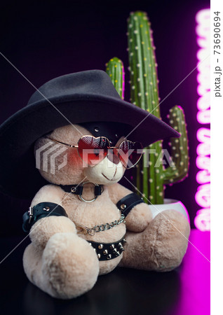 toy bear with heart shaped glasses and a cowboy hat on a leather belt accessory for BDSM games Valentine's Day gift toy bear with heart shaped glasses and a cowboy hat on a leather belt accessory for BDSM games Valentine's Day gift 73690694