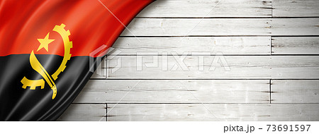 Angolan flag on old white wall banner 73691597