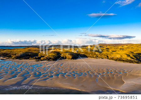 The coast between Kiltoorish bay beach and the Sheskinmore bay between Ardara and Portnoo in Donegal - Ireland The coast between Kiltoorish bay beach and the Sheskinmore bay between Ardara and Portnoo in Donegal - Ireland 73695851