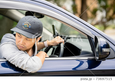 車を運転する男性 73697515
