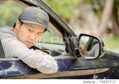 車を運転する男性 73697517