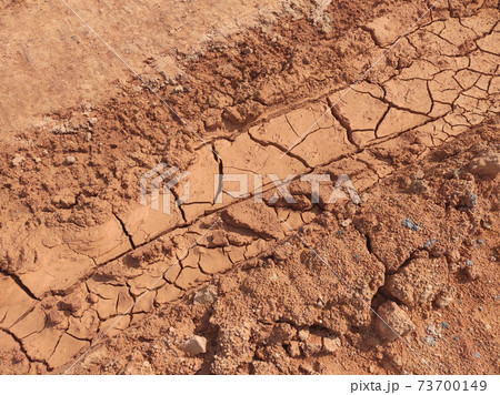 Mudlands that previously contained water have cracked due to hot weather and drought. All water content has been evaporated by the heat 73700149