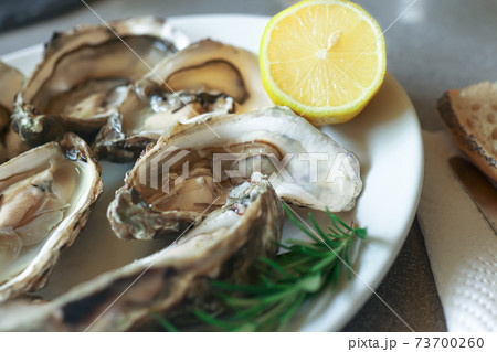White plate with oysters and lemon White plate with oysters and lemon 73700260