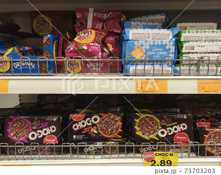 KUALA LUMPUR, MALAYSIA -JUNE 12, 2020: Variety of biscuits in good and interesting packaging and displayed on the racks inside the shop. Sort by brand to make it easier for customers to buy. KUALA LUMPUR, MALAYSIA -JUNE 12, 2020: Variety of biscuits in good and interesting packaging and displayed on the racks inside the shop. Sort by brand to make it easier for customers to buy. 73703203