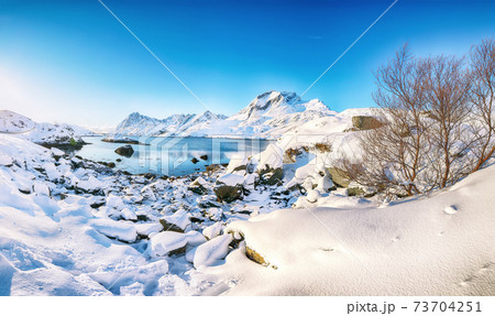 Fabulous winter view on Sundstraumen strait that separates Moskenesoya and Flakstadoya islands. Fabulous winter view on Sundstraumen strait that separates Moskenesoya and Flakstadoya islands. 73704251