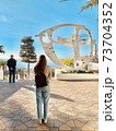 A statue and a girl on the Black Sea coast 73704352