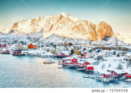 Dramatic evening cityscape of Reine town 73704539