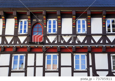 Decorated facade of medieval half-timbered house in Goslar, Germany. 73705911