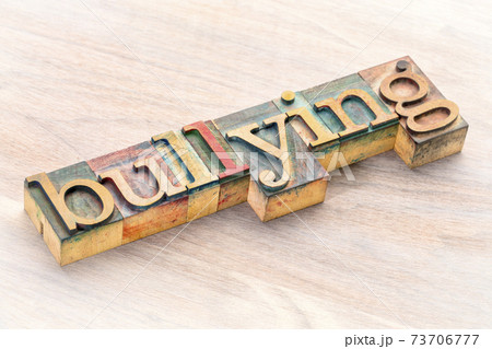 bullying word abstract in wood type 73706777
