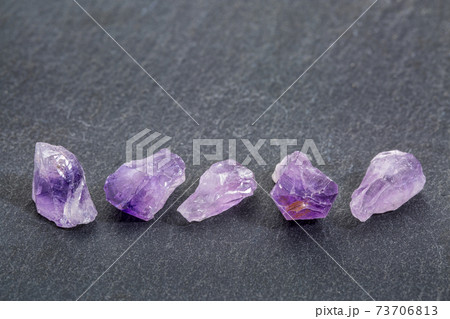 amethyst gemstones on slate stone 73706813