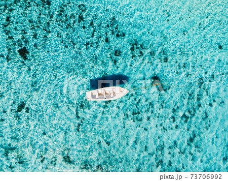 White boat in blue ocean in paradise island. Aerial view. 73706992