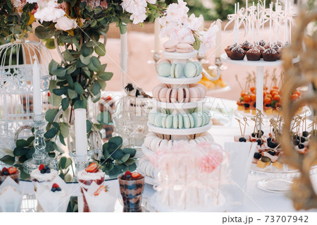 Sweet table at the wedding. Table with cakes and sweets at the festival Sweet table at the wedding. Table with cakes and sweets at the festival 73707942