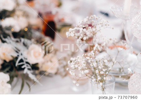 decoration with fluffy flowers on the table in winter style at the wedding 73707960
