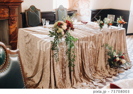 wedding table decoration with flowers on the table in the castle, table decor for dinner by candlelight.Dinner with candles 73708003