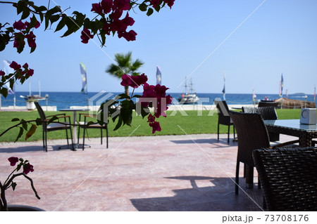 A cozy cafe with beautiful views of the blue sea and the sailing ship in a pirate style. 73708176