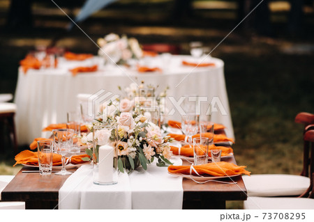 wedding table decoration with flowers on the table in the castle, table decor for dinner by candlelight.Dinner with candles 73708295