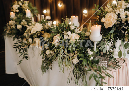 wedding table decoration with flowers on the table, candlelit dinner table decor. 73708944